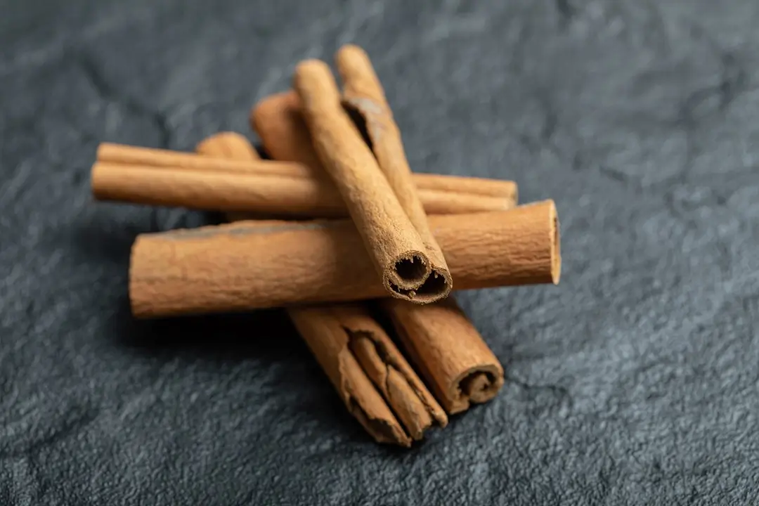 top-view-cinnamon-sticks-isolated-dark-surface